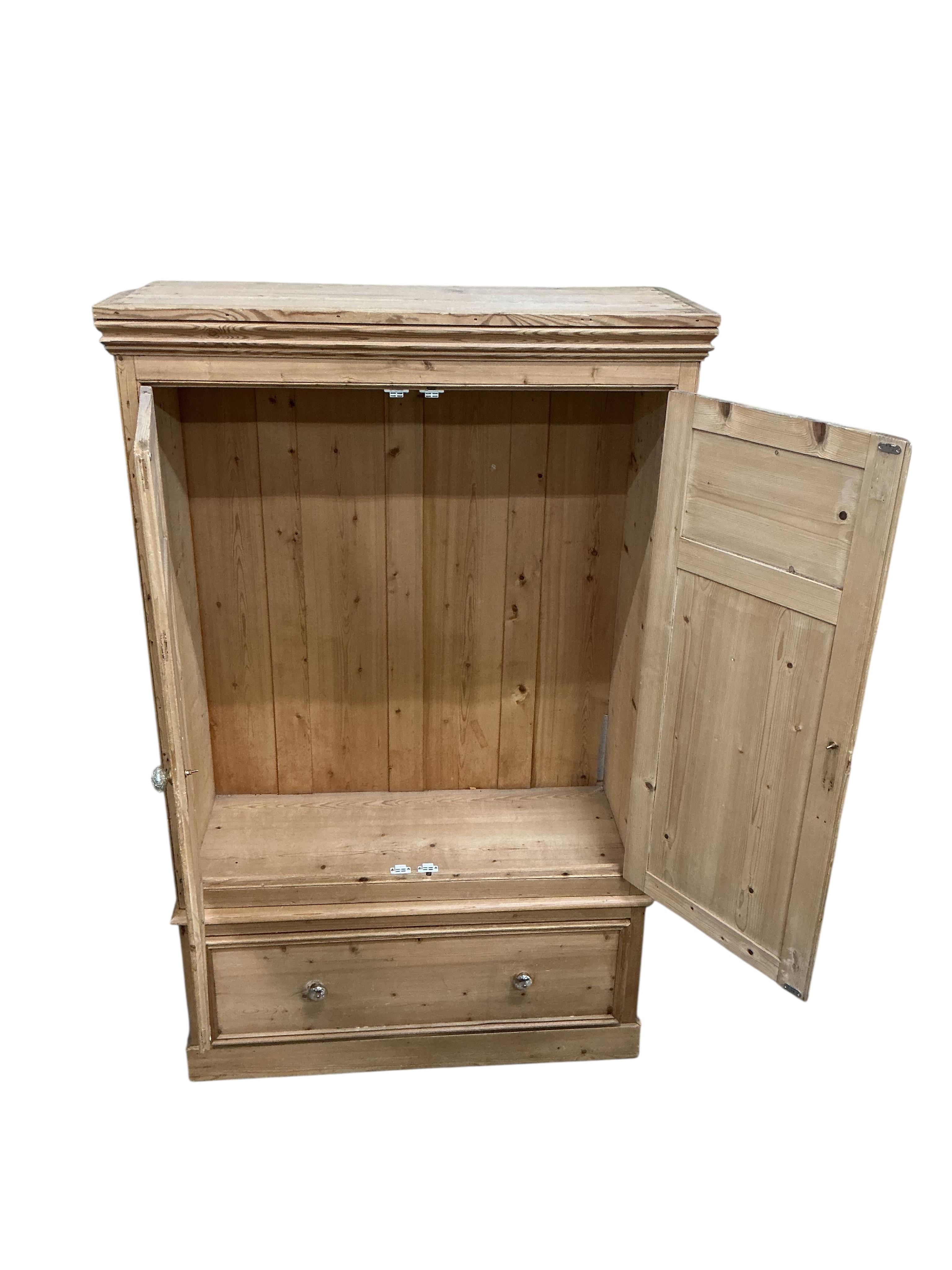 A late Victorian panelled pine two door wardrobe, width 114cm, depth 50cm, height 185cm